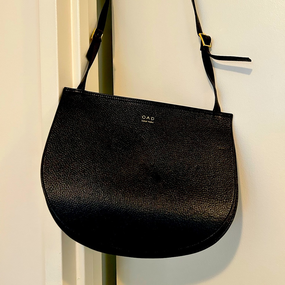 OAD black leather bag with adjustable shoulder strap; never used.